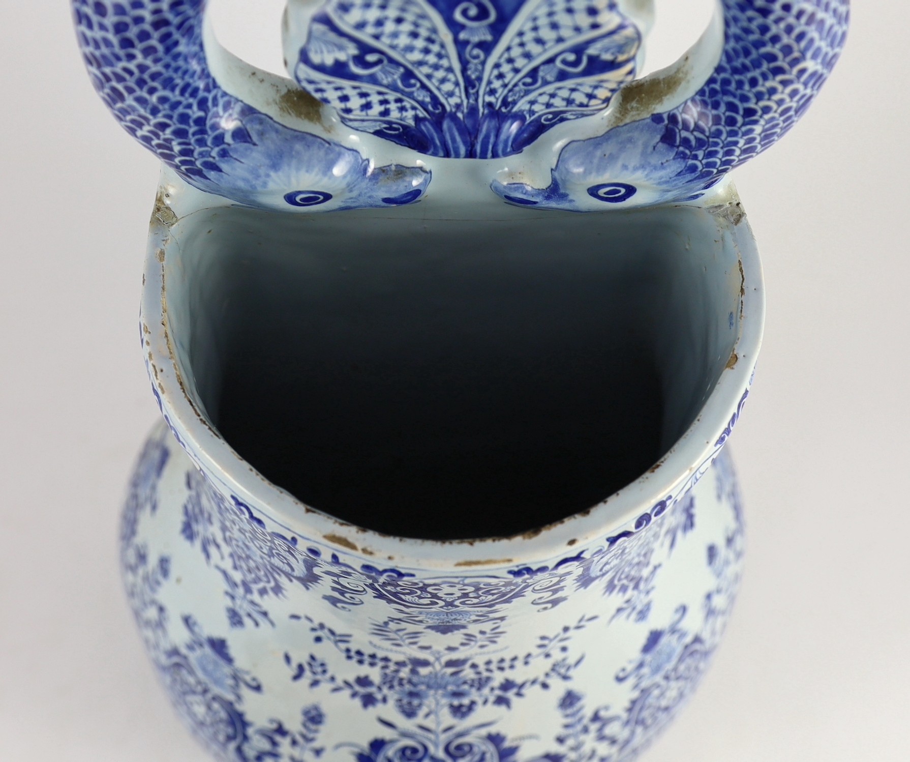 A large Rouen faience blue and white cistern, second quarter 18th century, 57.5cm high, restorations